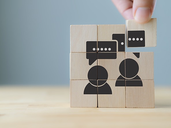 speech bubbles and outlines of people on wooden blocks